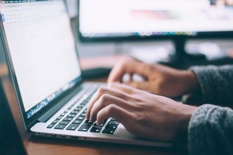 hands typing on keyboard